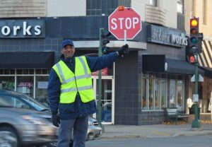 Crossing guard holding a Stop Sign